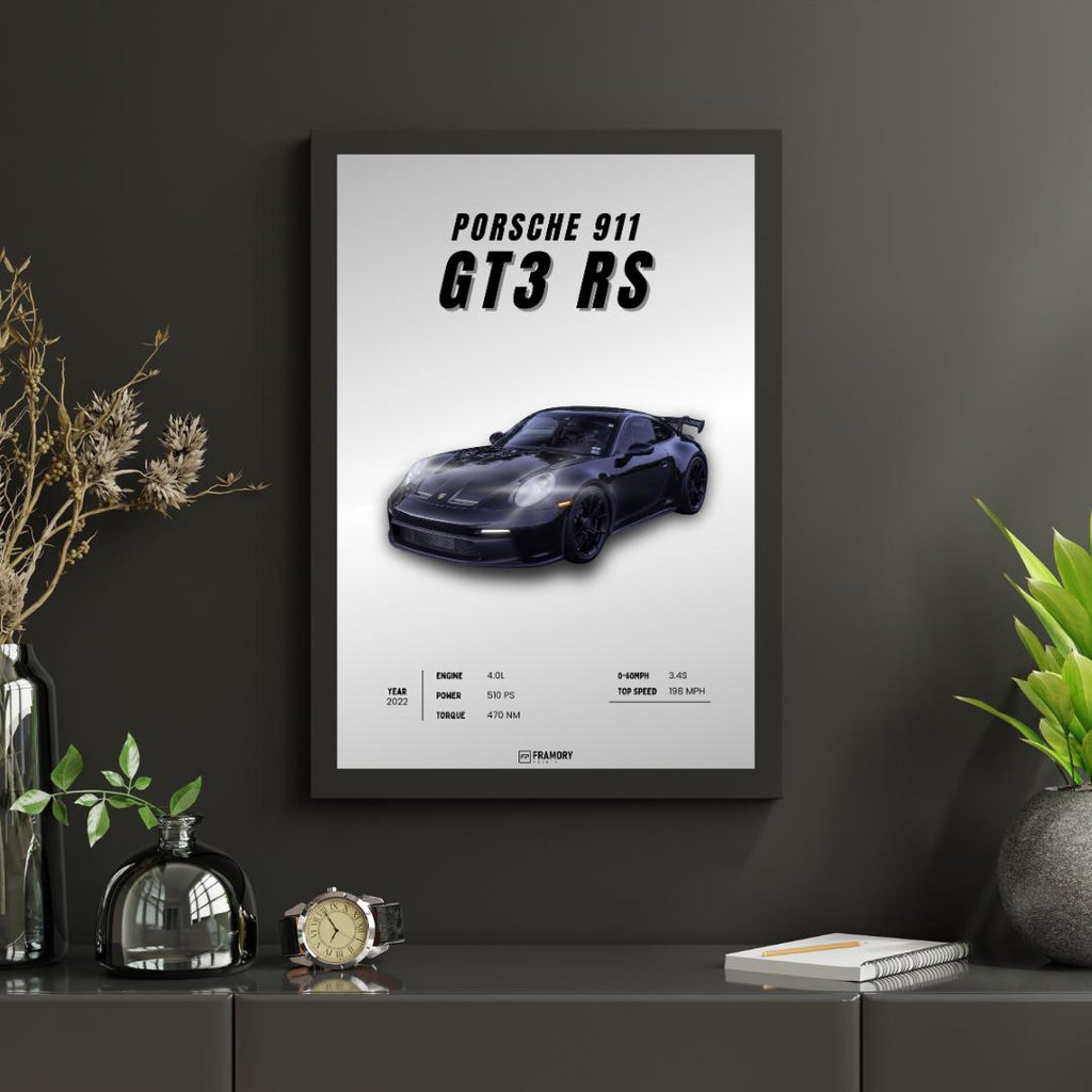 Framed poster of a Porsche 911 GT3 RS on a dark wall with decorative items.
