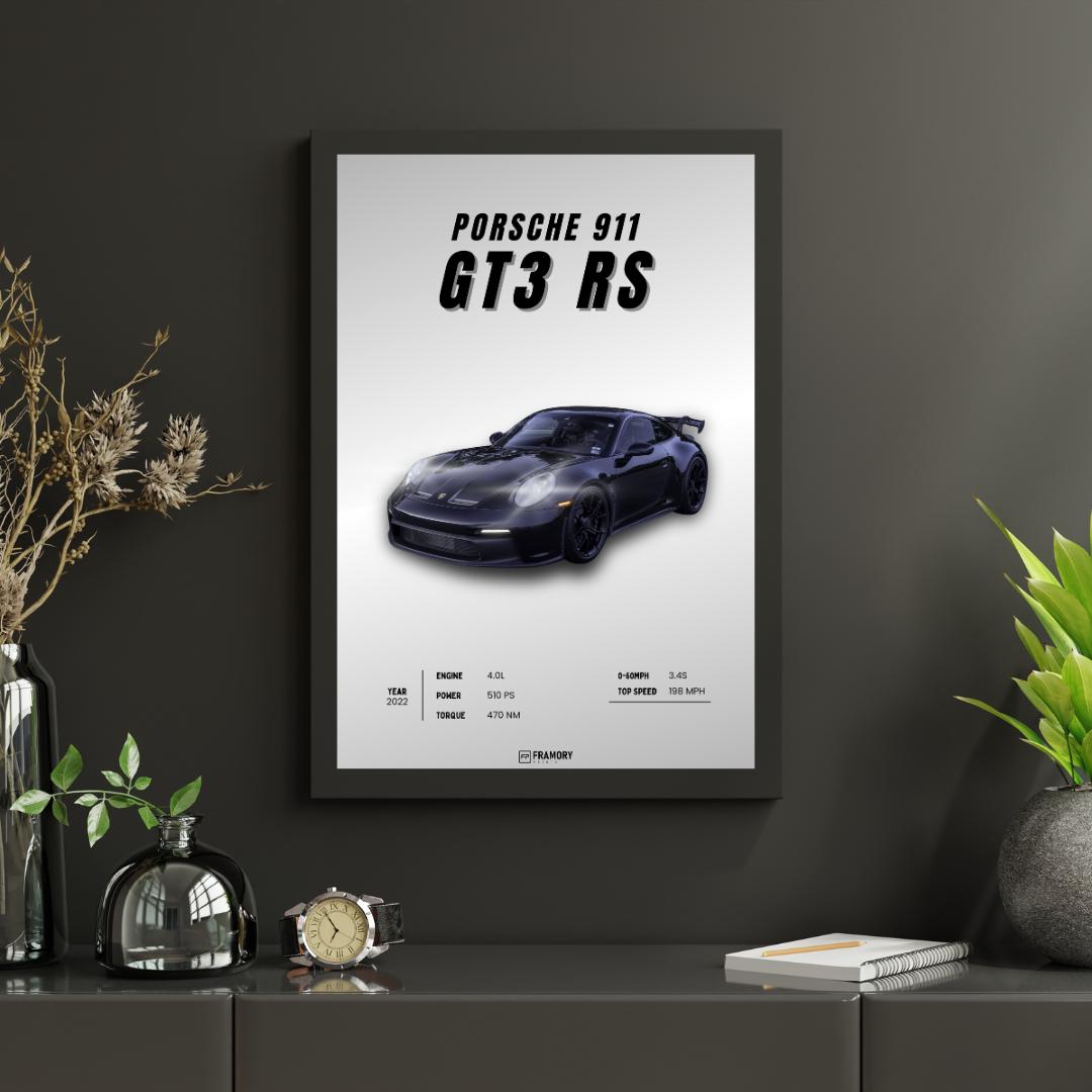 Framed poster of a Porsche 911 GT3 RS on a dark wall with decorative items.